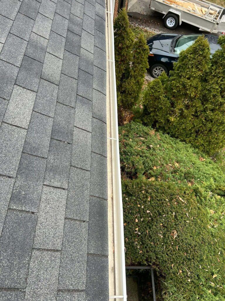 High-pressure rinse being applied to a cleaned eavestrough as part of HRPM’s Triple-Flush Method.