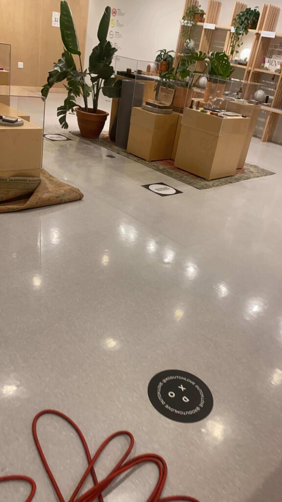 Polished retail showroom floor with waxed finish, adjacent carpeting edge, cleaned by HRPM.
