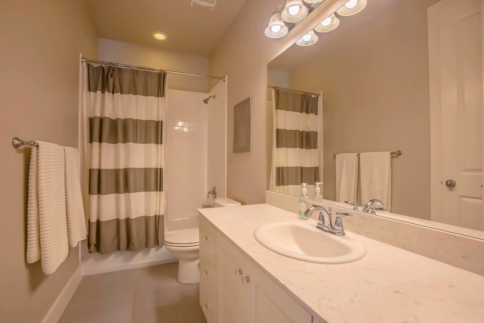 Clean and well-maintained bathroom with polished fixtures and fresh towels, reflecting high cleanliness standards guests expect